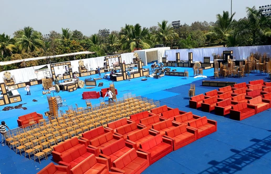 Aerial view of a large outdoor event production with stage, lounge seating and hundreds of chairs, built by SEM in Mumbai
